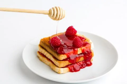 Toast bread with raspberry jam on plate Stock Photos