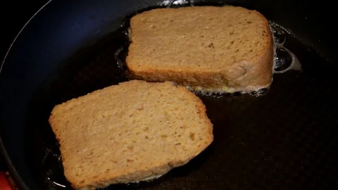 Toast cooking. Chef doing toast. French toast cooking in frying pan Stock Footage 93553643