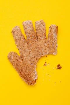 Toast hand shape with bite mark and crumbs Stock Photos