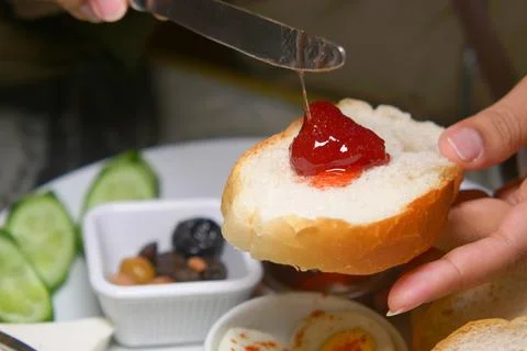 Toast with jam and assorted sides in a cozy breakfast setting Stock Photos
