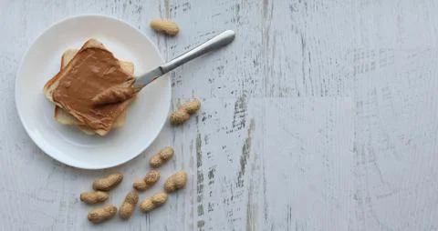 Toast with peanut paste on a white background, flat lay copyspace Stock Photos