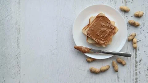 Toast with peanut paste on a white background, flat lay copyspace Stock Photos