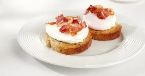 Toast with poached egg and bacon. sunny day. angle view. smooth zoom camera. Stock Footage 242042148