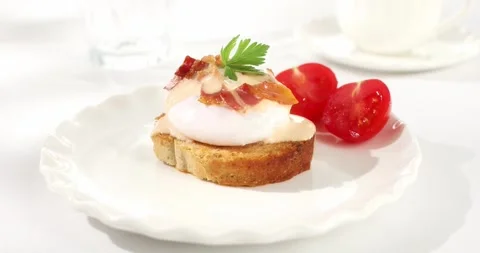 Toast with poached egg and bacon. sunny day. angle view. smooth zoom camera. Stock Footage 243228839