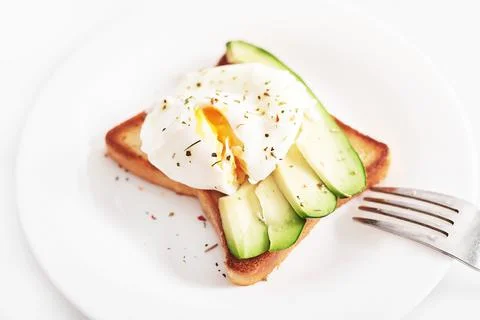 Toast with poached eggs and avocado. Healthy breakfast and food. Cozy morning Stock Photos