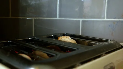 Toast pops up from a toaster Stock Footage 98659692