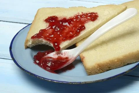 Toast with raspberry jam on a plate, breakfast Stock Photos