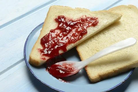Toast with raspberry jam on a plate, breakfast Stock Photos
