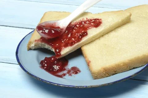 Toast with raspberry jam on a plate, breakfast Stock Photos