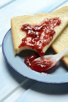 Toast with raspberry jam on a plate, breakfast Stock Photos