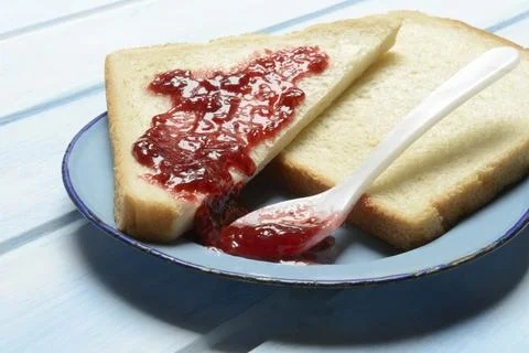 Toast with raspberry jam on a plate, breakfast Stock Photos