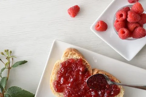 Toast with raspberry jam on plate freshly prepared for breakfast Stock Photos