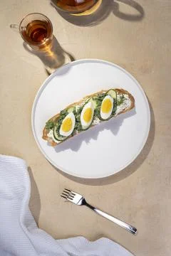 Toast with toasted bread soft-boiled eggs with yellow yolk and with herbs on Stock Photos