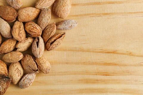 Toasted almonds in shell on kitchen board with copy space Stockfoto's