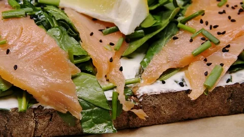 Toasted bread with avocado, poached eggs and salmon. Side view Stock Footage 127507031