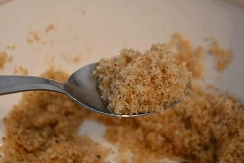 Toasted bread crumbs on spoon cheap food concept Fotos de archivo