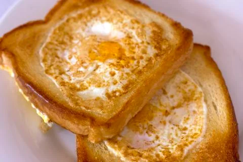 Toasted bread fried with egg inside. Isolated Stock Photos