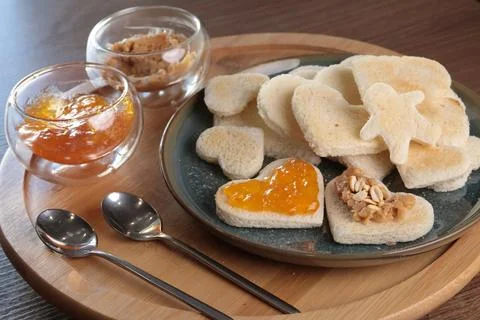 Toasted bread hearts with peanut butter and jam. Breakfast for holidays. Food Stock Photos