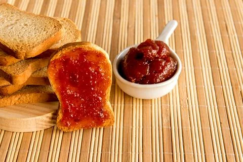 Toasted bread with jam on breakfast table. Stock Photos