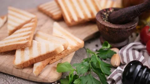 Toasted bread pieces sliced in a half on wooden cutting board 스톡 동영상 209181468