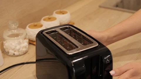 Toasted bread pops out of the toaster. Fresh golden brown bread is ready for Stock Footage 276343316