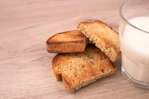Toasted bread slices with appetite crispy crust and the glass of fresh milk Stock Photos