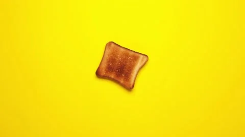 Toasted bread slices moves on yellow background.  Stock Footage 151318687