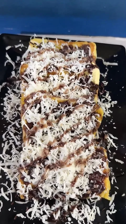 Toasted bread topped with chocolate sprinkles and cheese Indonesian snack Stock Footage 274115239