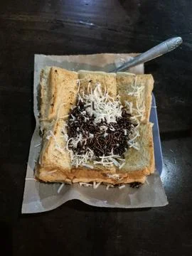 Toasted bread topped with shredded cheese and choco Stock Photos