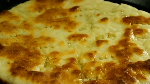 Toasted greasy flatbread is fried in cooking oil in pan. Stock Footage 131441015