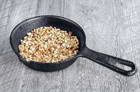 Toasted pine nuts in a pan Stockfoto's