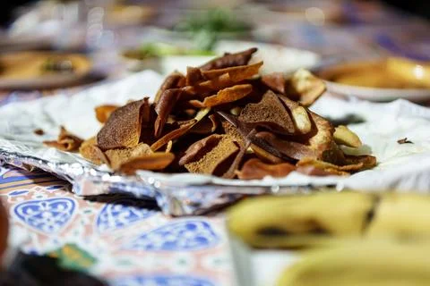 Toasted pita bread appetizer on patterned tablecloth Stock Photos