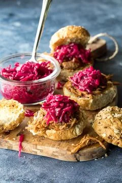 Toasted pulled pork buns topped with pickled red cabbage and beet sauerkraut. Stock Photos