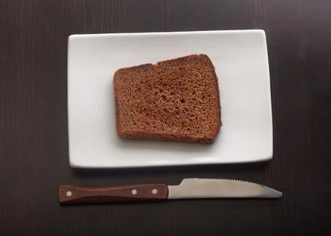 Toasted rye bread on the white plate Stock Photos