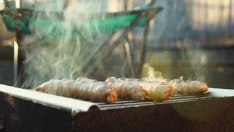 Toasted sausages lie on the barbecue grill in the smoke. Stock Footage 115122953
