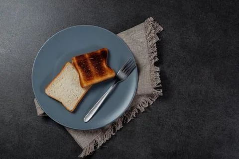 Toasted slice of bread on white plate Stock Photos