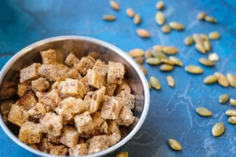 Toasted slices of bread, crackers for soup with seeds in the background Stock Photos