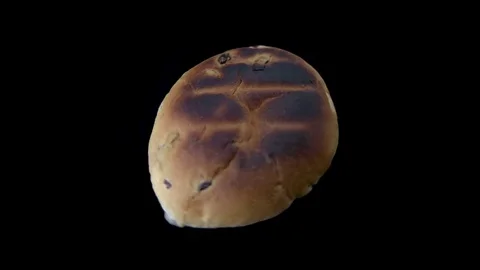Toasted teacake spinning on black background Stock Footage 82367243