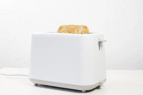 Toaster with bread inside on the table. breakfast, lunch. slices of bread. .. Stock-Fotos