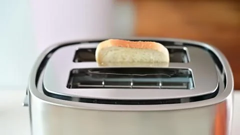 Toaster with bread slice popping up in a modern kitchen Stock Photos