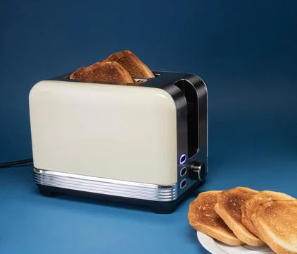 Toaster with cooked toasts on a blue background Stock Photos