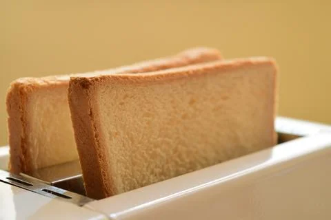 Toaster with pieces of bread Stock Photos