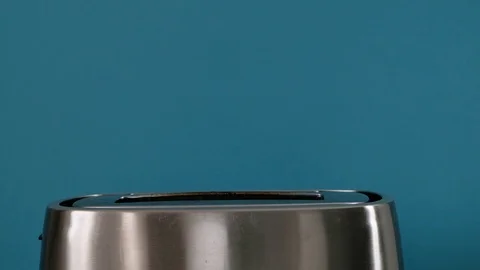 Toaster with white bread on blue background, close up Stock Footage 120769464