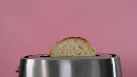 Toaster with white bread on pink background, close up Stock Footage 120769493