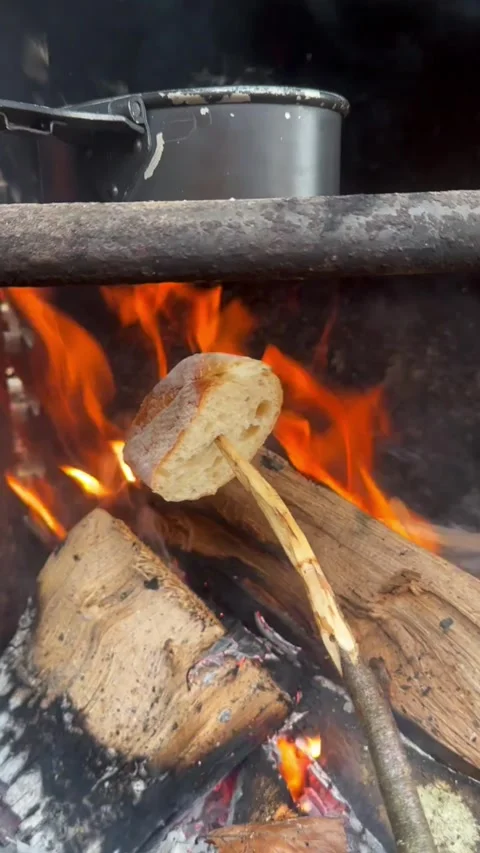 Toasting Bread and Brewing Tea Over a Forest Campfire Stock Footage 296501414