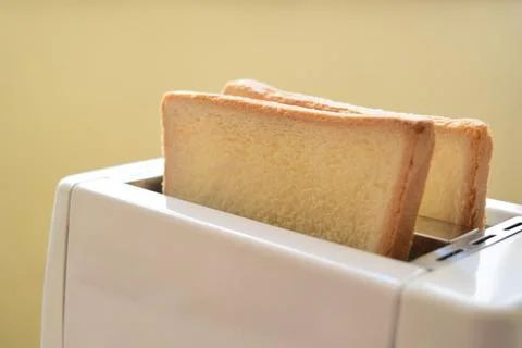 Toasting bread for breakfast Stock Photos