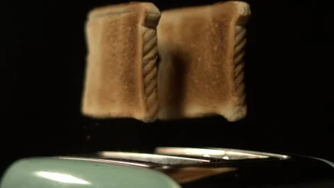 Toasting bread in a kitchen toaster at home during breakfast time Stock Footage 331383904