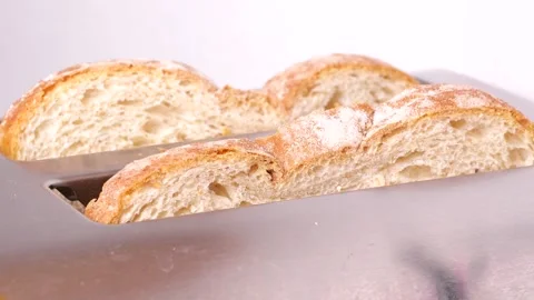 Toasting bread slices in slow motion on white background Stock Footage 306415393