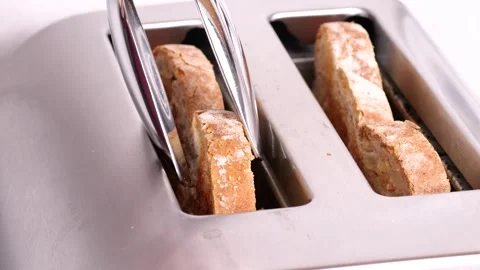 Toasting bread slices in slow motion on white background Stock Footage 306415724