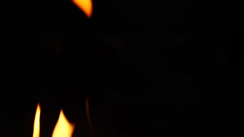 Toasting marshmallows over an open fire at a campsite in autumn Stock Footage 281816042